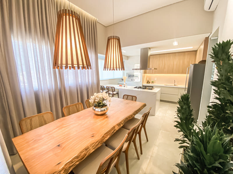 Dining Room decorated in open concept, and Accord pendants highlighted above the wooden table.